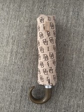 Dooney  Bourke umbrella with a repeating "DB" logo print.