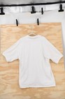 White vintage Harley-Davidson Sturgis 2002 men’s 2XL polo shirt with short sleeves, shown on a wooden background.