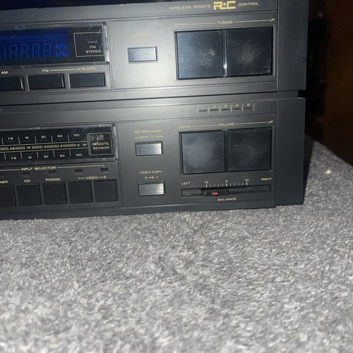 Marantz ST-100 tuner and PM100 amplifier with black front panels, gold lettering, and labeled buttons for input selection.