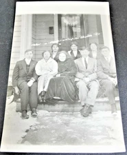Group of family members sitting on Porch - Real Photo Postcard-AZO (1904-1918). 