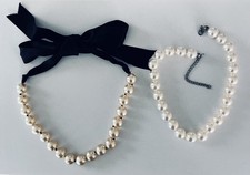 Set of two pearl necklaces chocker black satin ribbon bow. One ivory. One white.