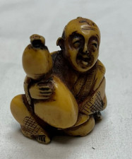 Netsuke Man Holding a Large Sack Carved Resin...