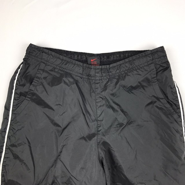 nike black pants with white stripes
