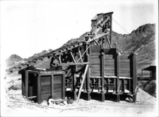 Rail car at top of the ore dump at mine run by Free Gold Mining Co - Old Photo