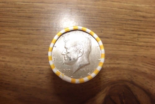 kennedy half dollar roll with a 40% silver 1965  half on end in vV- good cond.