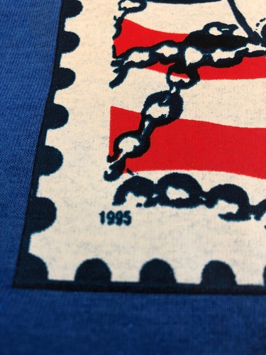 Blue vintage 1995 T-shirt with red POW MIA banner and black chains, labeled “USA Made.”
