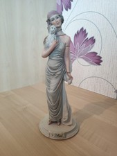 A Belcari Figurine 1987 Dear Lady Holding Dog Round Base