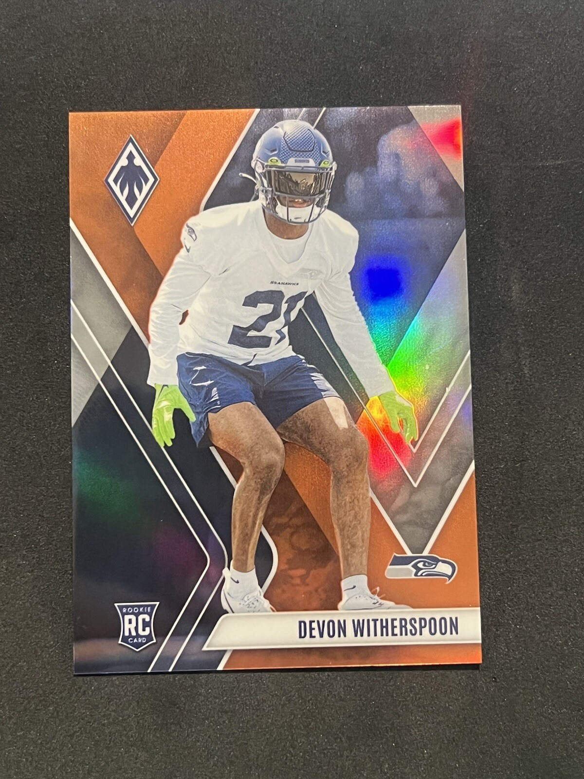 2023 Panini Phoenix - Rookies Orange #145 Devon Witherspoon /99 (RC)