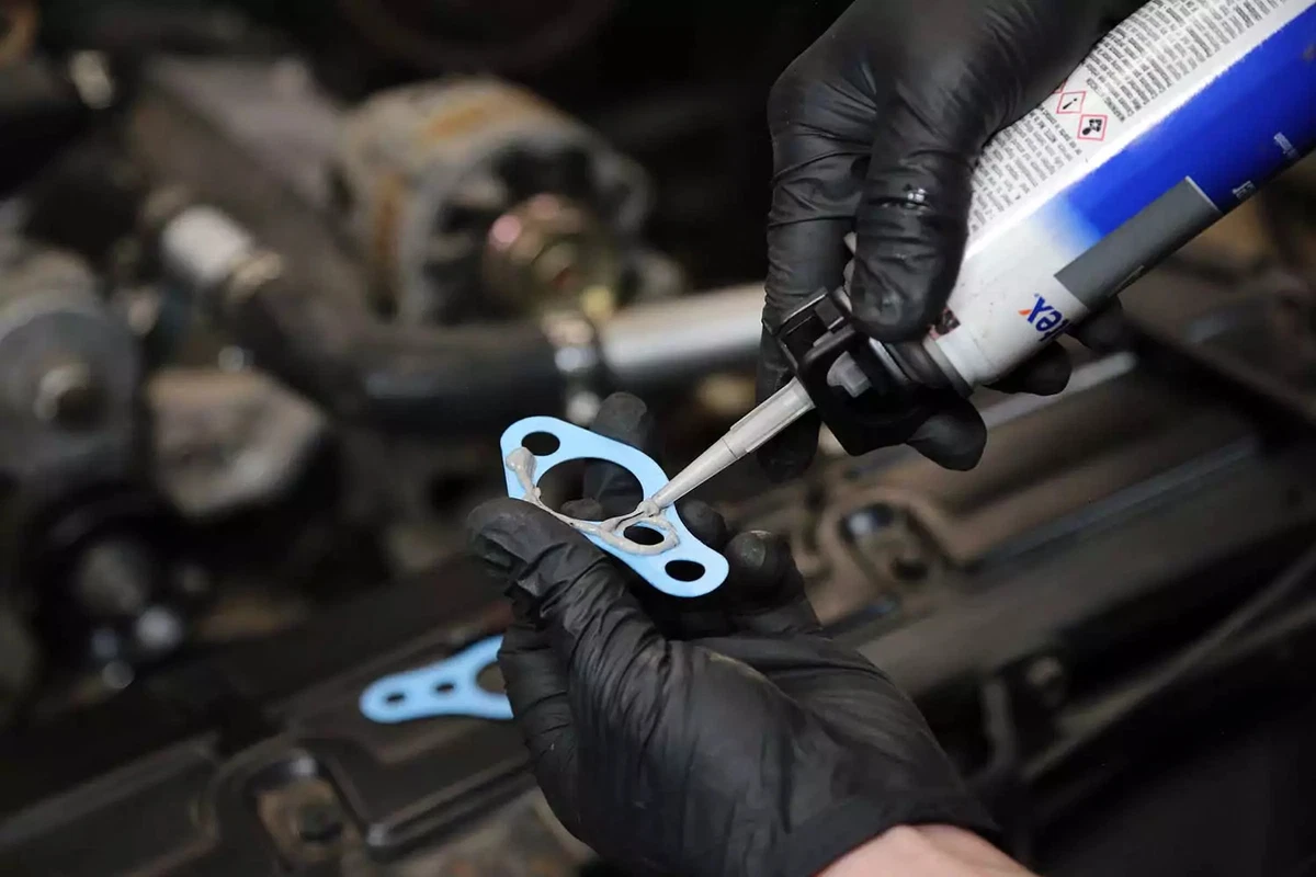 RTV silicone is applied to the water pump gasket prior to installation.