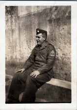 WW2 Photo U.S. Army First Sergeant in Uniform, Sitting by Wall