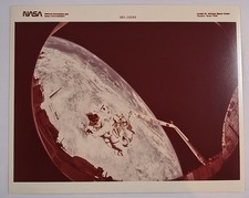 Vintage Nasa Photo Of A Astronaut Performing an spacewalk with a Background