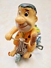 NICE WIND UP TIN AND CELLULOID FRED FLINTSONE ON TRICYCLE BY MARX, JAPAN.