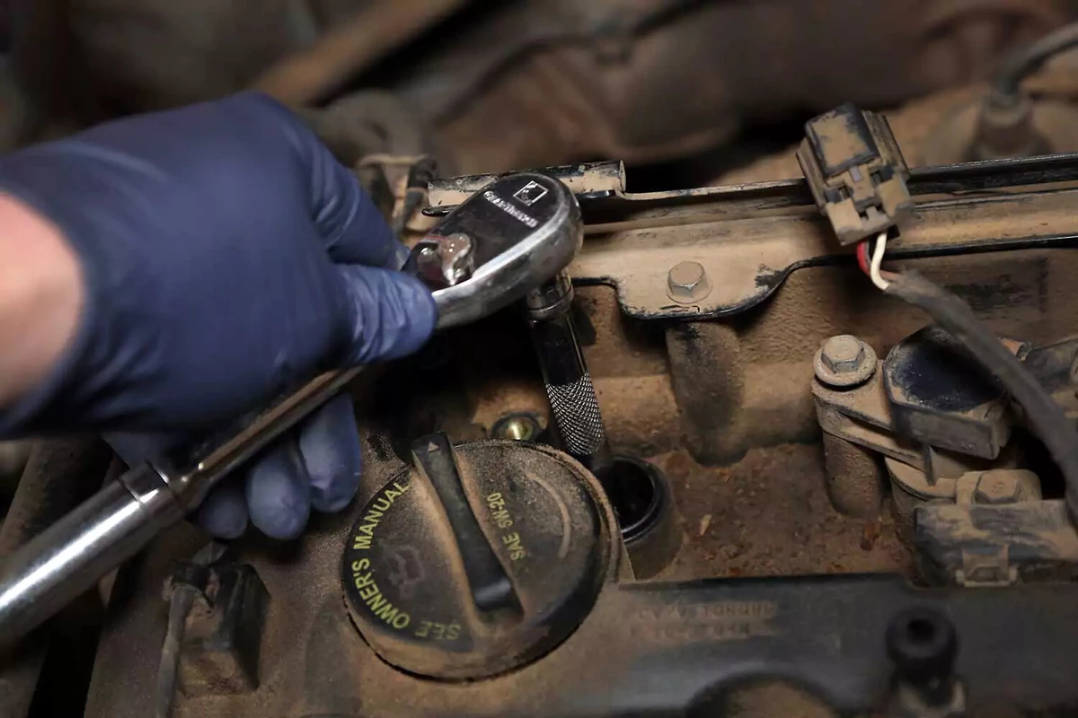 Ratchet and socket being used to remove a spark plug.