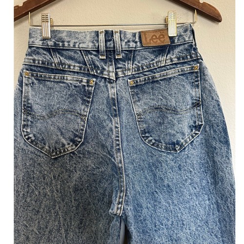 Back view of 90s vintage Lee High Rise Mom Jeans in blue distressed denim with two pockets and brown leather patch on waistband.