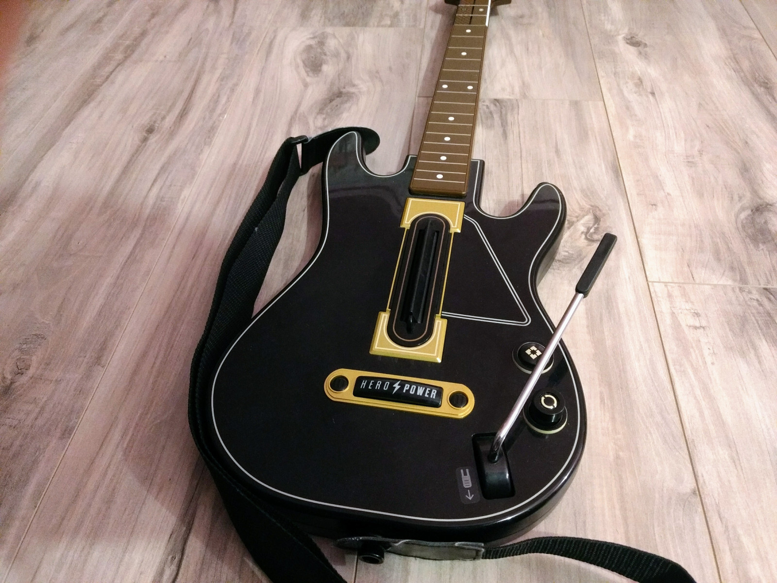 Used black Guitar Hero controller Hero Power Guitar Model 0000654. No