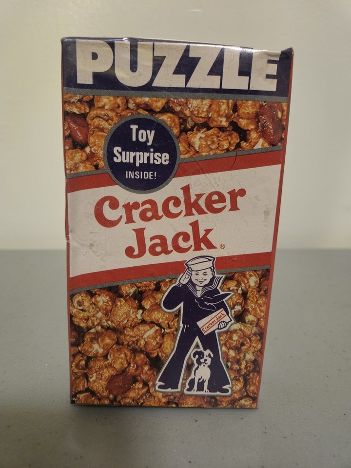 A genuine vintage Cracker Jack prize puzzle with joke book — a tiny, affordable nostalgia bomb from the golden age of snack-box surprises.