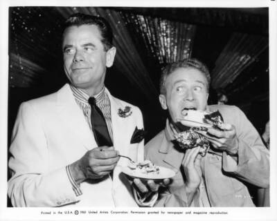 Glenn Ford looking away as he eats cake off camera from the film P- Old Photo