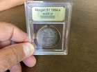 1884-S  MORGAN DOLLAR in sealed old slab graded 55 original US MINT coin toned