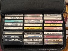 Lot of cassettes: country, folk, and strings with large capacity carrying case. 