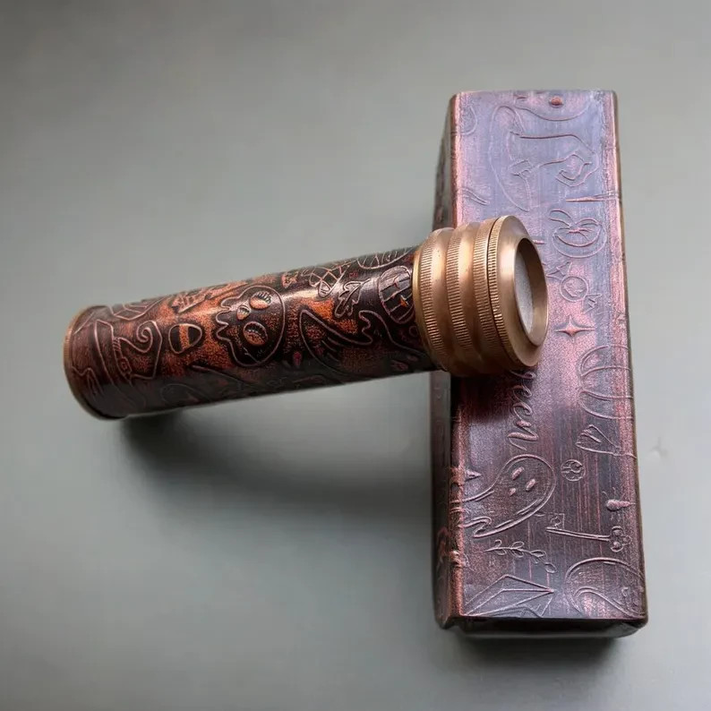 A working brass telescope with leather wrap — actually functional vintage optics that double as a handsome desk or mantle object.