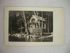 VINTAGE REAL PHOTO POSTCARD FRANCORA COTTAGE ON LAKE WITH OLD BOAT CIRCA 1905