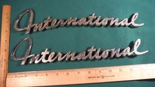 CD83 International Harvester Hood Side Emblems Vntage Script 1960s 242692 LOAD 