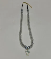 Mummy Halloween pendant with glow in the dark beads on a cord necklace.