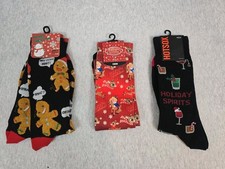 three pairs novelty crew socks for men, featuring designs themed around...