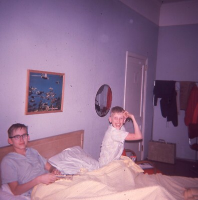 1960's era Slide Young Brothers in Hotel Room Bed One Flexing his Muscles