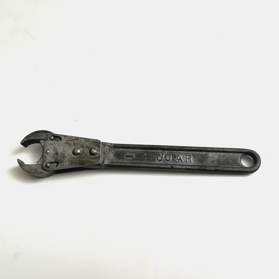 A palm-sized vintage 'JOAR' adjustable pipe wrench from a forgotten era of tool-making — the kind of oddity that looks like a prop from a steampunk workshop.