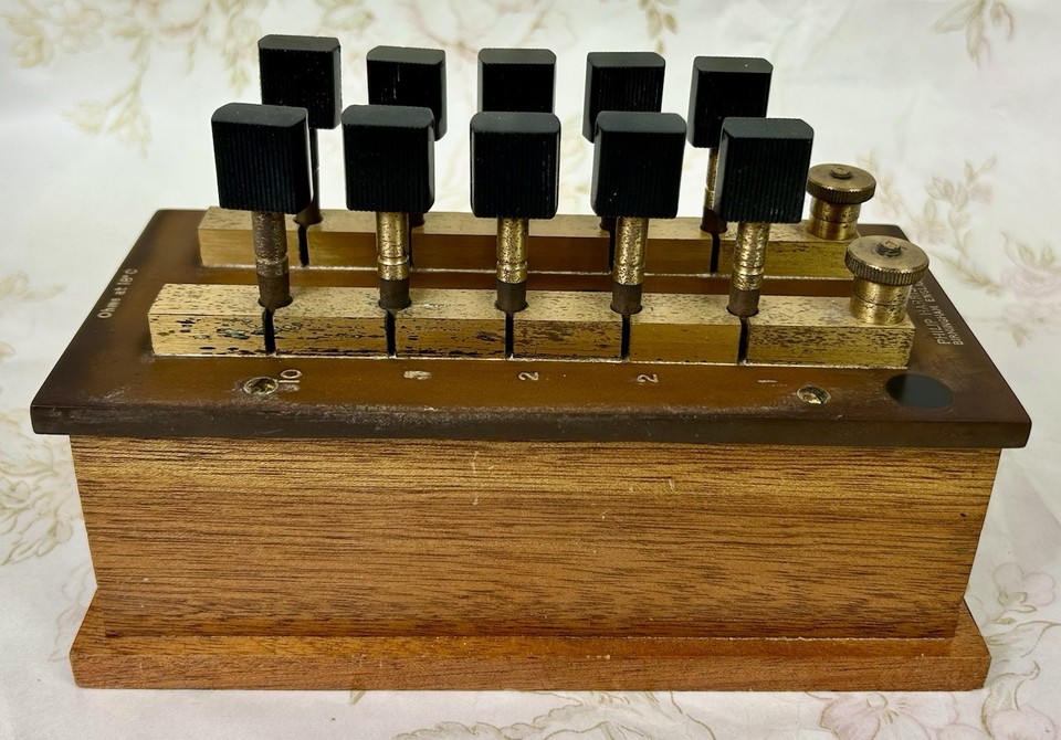 A Philip Harris plug-key resistance box — the exact kind of hand-built scientific instrument that made electricity feel like actual magic.