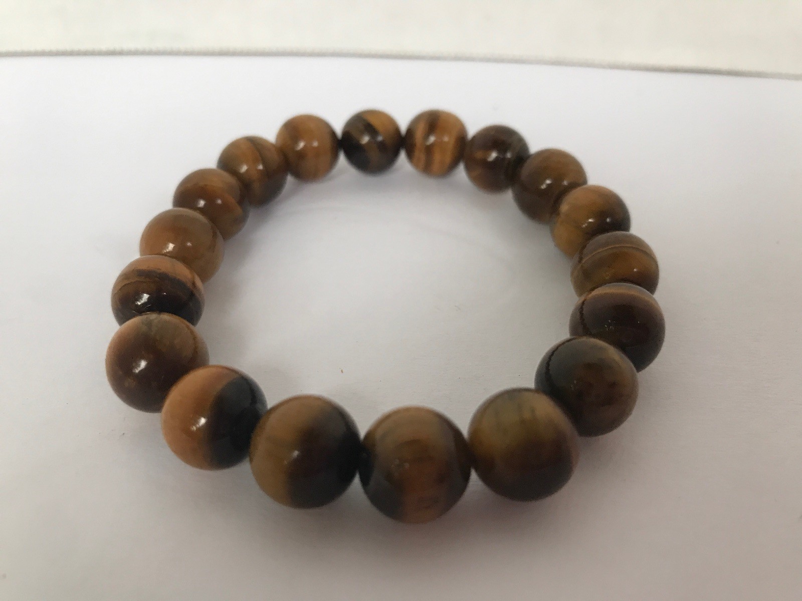 Stretchy brown howlite bangle with glossy round beads in earthy tones-image