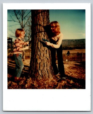Child Woman Toy Gun 1970s Snapshot Photograph Outdoor Tree Vintage