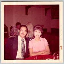 Vtg Color Snapshot Couple Sitting Restaurant Dinner Table Eyeglasses Oct 1972