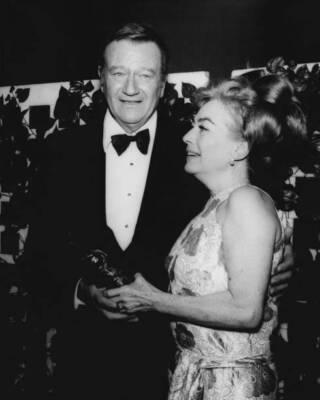 John Wayne and Joan Crawford hold a trophy at 27th Annual Golden G- Old Photo