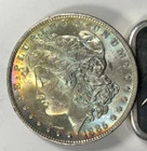 1885-O Toned Morgan Dollar. $Attractive Multi-Color Full Spectrum Obverse Tone.