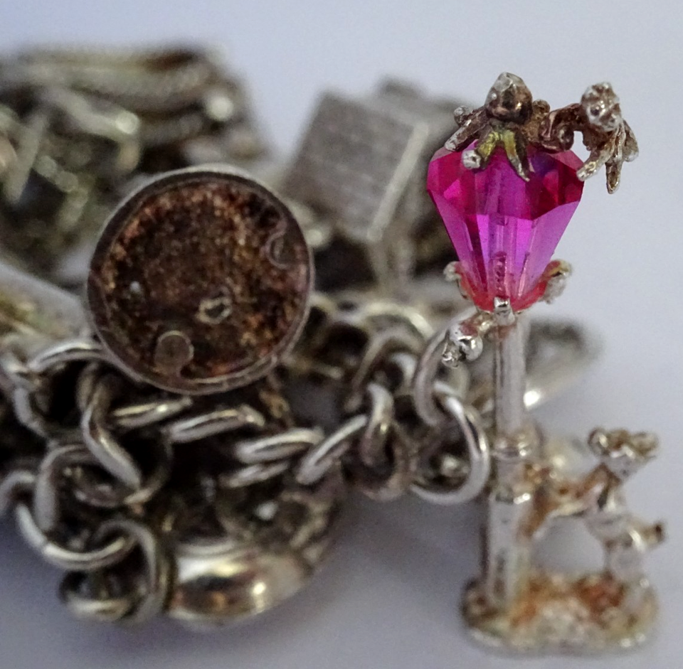 Vintage heavy solid silver charm bracelet &many curious silver charms ...