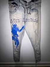 These men's jeans are GFTD branded streetwear denim featuring graphic prints and