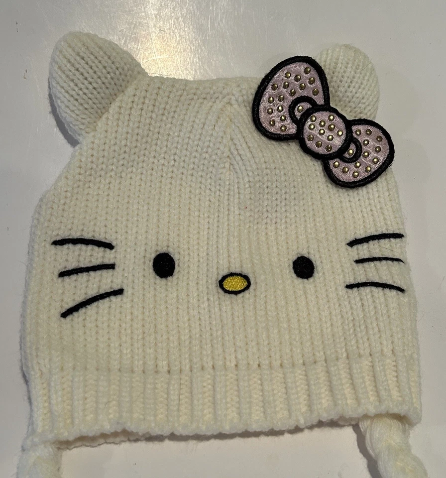 Gorra gorro tejido con cable lazo blanco rosa Hello Kitty niñas talla 4-14 con pompones colgantes Foto 2 de 4