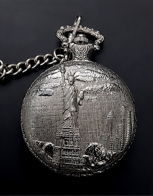 A vintage silver pocket watch with the Statue of Liberty on the dial — patriotic, quirky, and visually striking in a way that no modern watch can replicate.