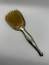 Vintage art deco Victorian vanity gold-tone hair brush with ornate silver handle
