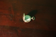 This image features a vintage-style Geneva quartz pocket watch.