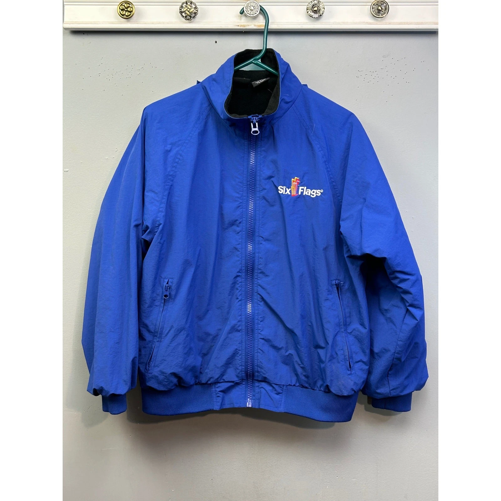 Six Flags Windbreaker Jacket Unisex XS Blue Fleece Lined Zip Up Stowaway Hood