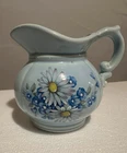 Mccoy pottery pitcher blue with painted Daisies flowers.