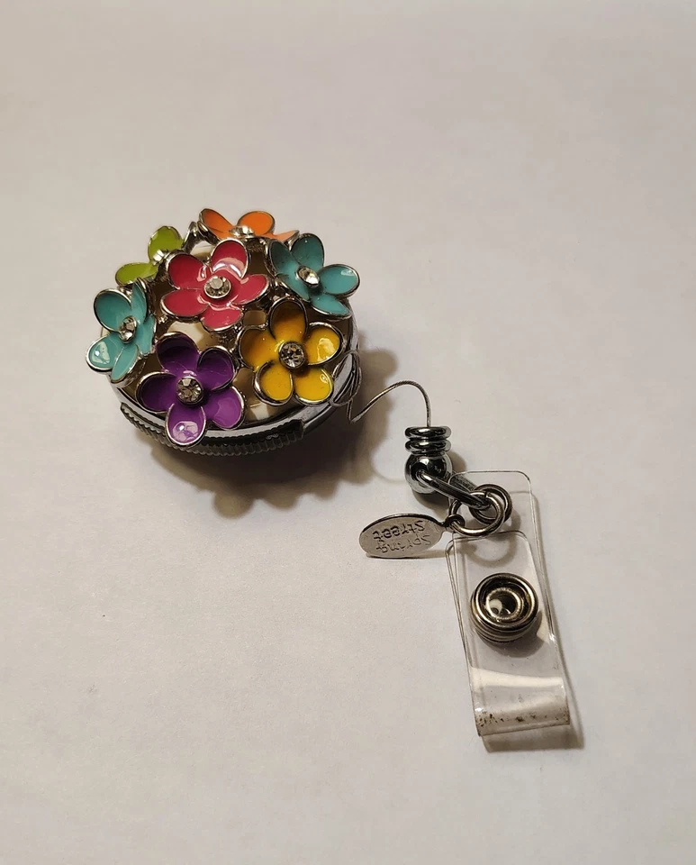 Soporte de insignia retráctil de flores coloridas - Etiqueta de cordón de carrete de metal de alta resistencia Foto 3 de 4