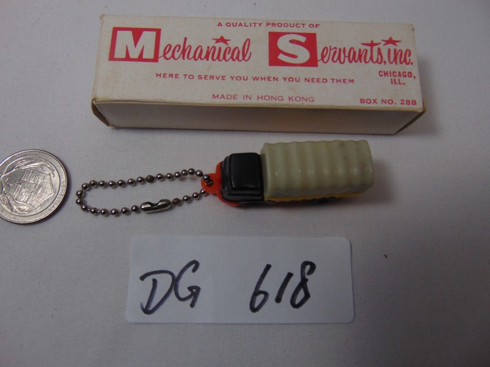 A Hong Kong–made vintage truck/tipper keychain puzzle toy — tiny, mechanical, and wonderfully obscure from an era of brilliantly cheap novelty imports.