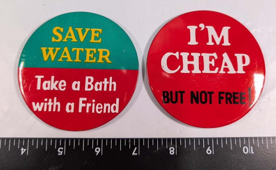 Vintage novelty pinback buttons with cheeky slogans like 'Save water, take a bath with a friend' — tiny wearable time capsules of 70s/80s sass.