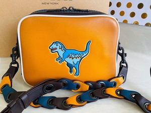 coach purse with dinosaur