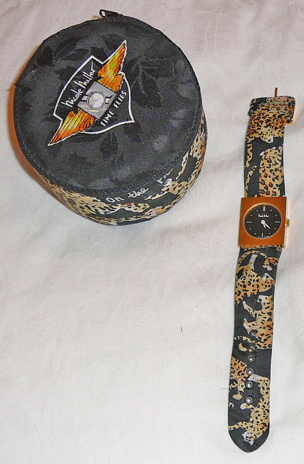 Nicole Miller TIME FLIES edition watch with fabric padded drum case, circa 1980s