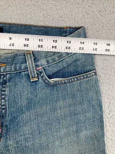 Blue stretch light wash Karen Kane women’s jeans with 9-16 leg, front pockets, and pink stitched detail on waistband.